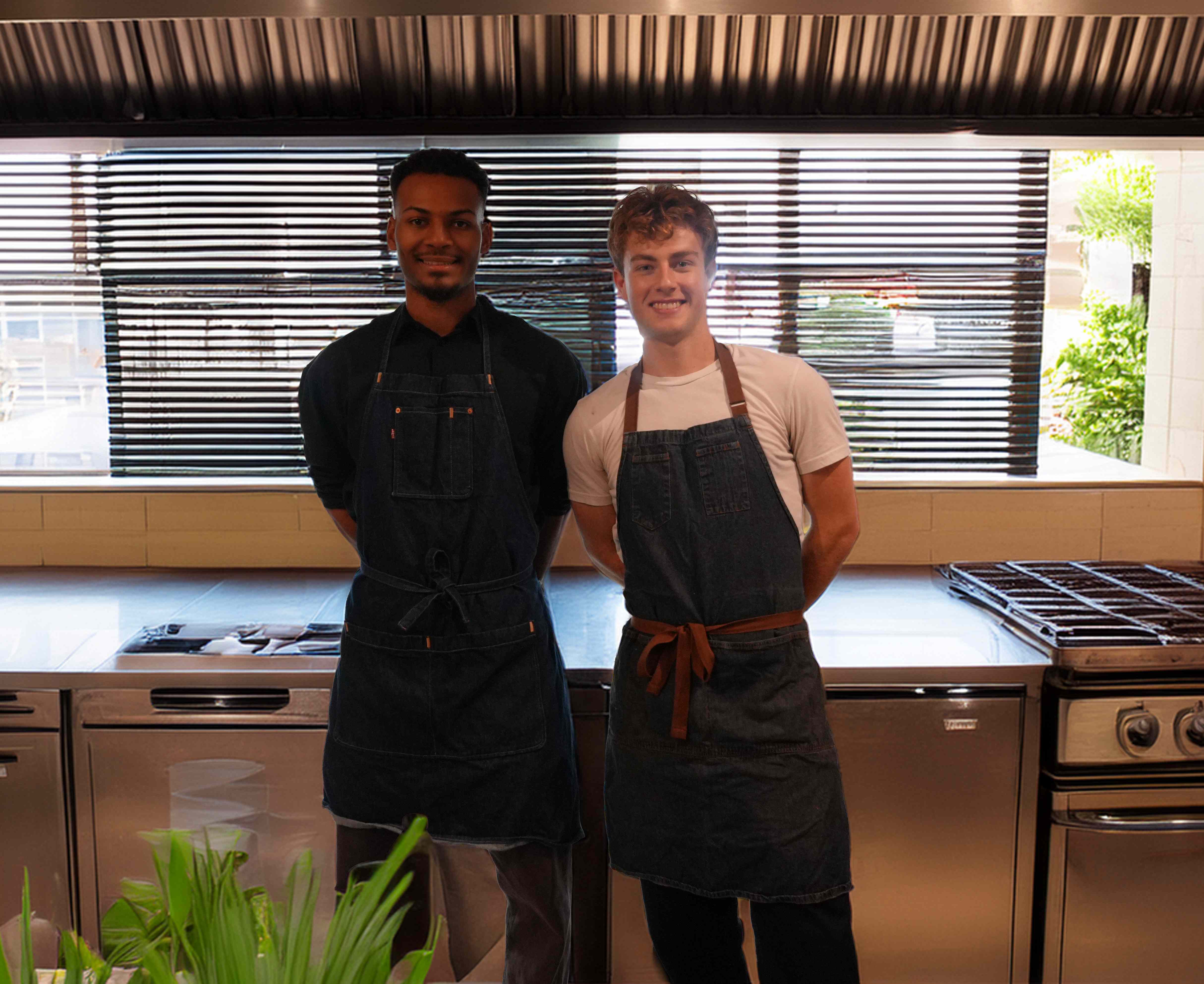 Private chefs Sam and Henry standing together in their apron